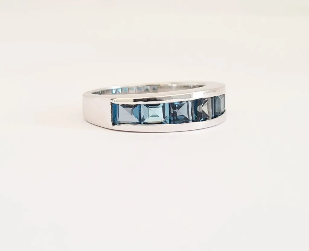 Contemporary Half Eternity Ring Featuring Seven Square Cut London Blue Topaz