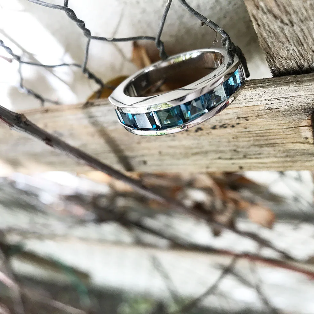 Contemporary Half Eternity Ring Featuring Seven Square Cut London Blue Topaz