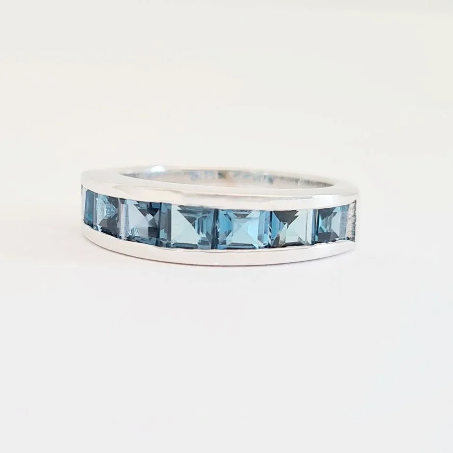 Contemporary Half Eternity Ring Featuring Seven Square Cut London Blue Topaz
